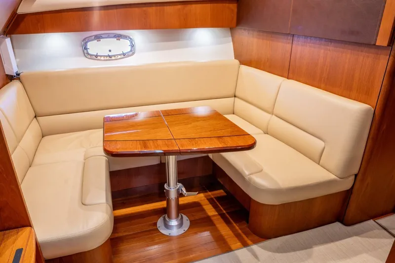 Teddy's Float Too Yacht Photos Pics Luxurious interior of 2015 Tiara Yachts 4300 Open with elegant wood and leather seating.