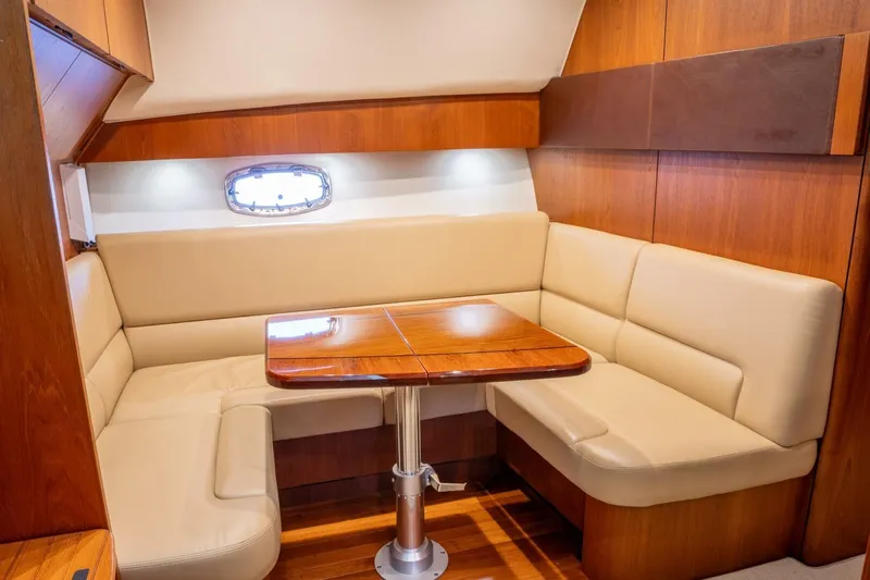 Teddy's Float Too Yacht Photos Pics Luxurious interior of 2015 Tiara Yachts 4300 Open with elegant seating and wooden table.