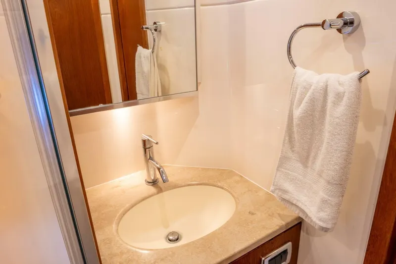 Teddy's Float Too Yacht Photos Pics Luxurious bathroom in 2015 Tiara Yachts 4300 Open, featuring elegant sink and towel holder.