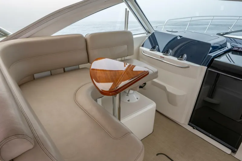 Teddy's Float Too Yacht Photos Pics 2015 Tiara Yachts 4300 Open interior with elegant seating and polished wood table.