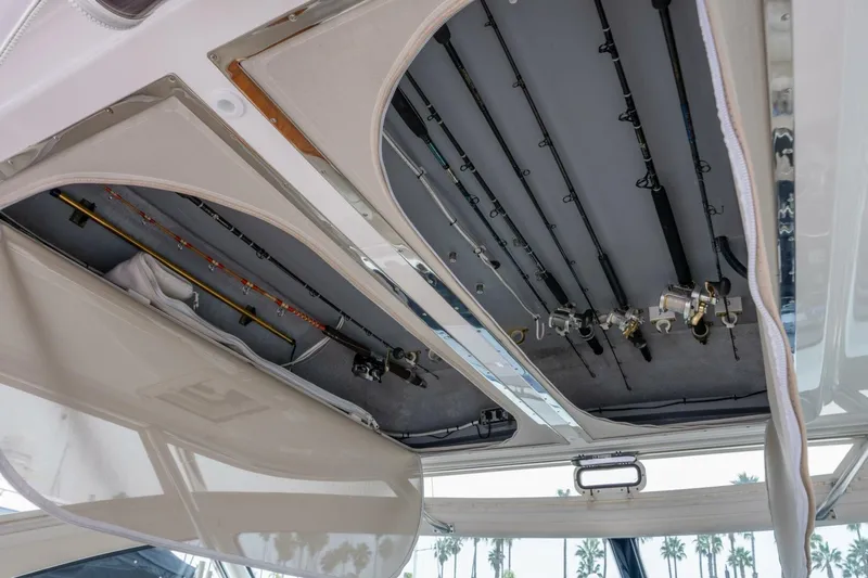 Teddy's Float Too Yacht Photos Pics 2015 Tiara Yachts 4300 Open fishing rod storage compartment with multiple rods and reels.