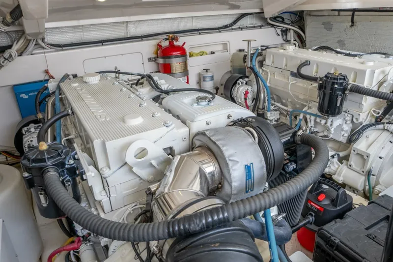 Teddy's Float Too Yacht Photos Pics Engine room of 2015 Tiara Yachts 4300 Open, featuring dual engines and fire extinguisher.
