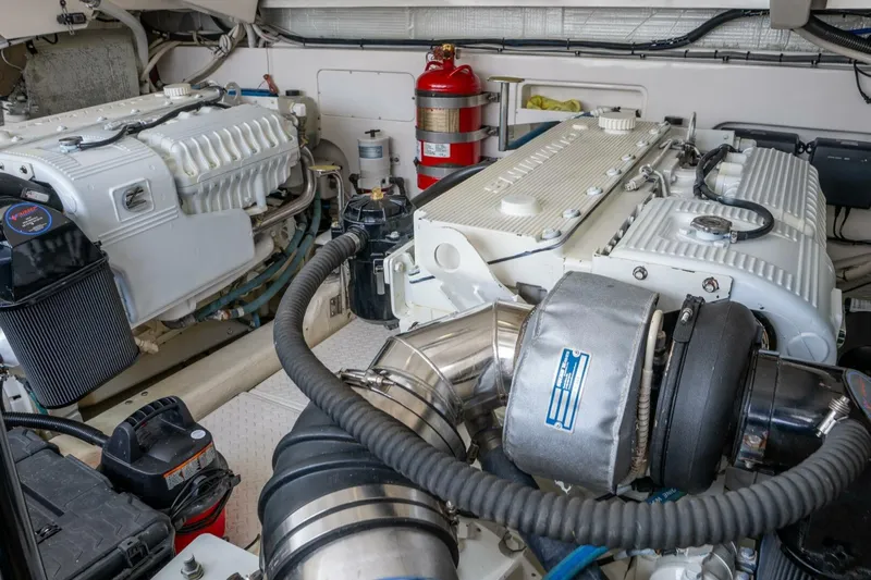 Teddy's Float Too Yacht Photos Pics Engine room of a 2015 Tiara Yachts 4300 Open, featuring dual engines and fire extinguisher.