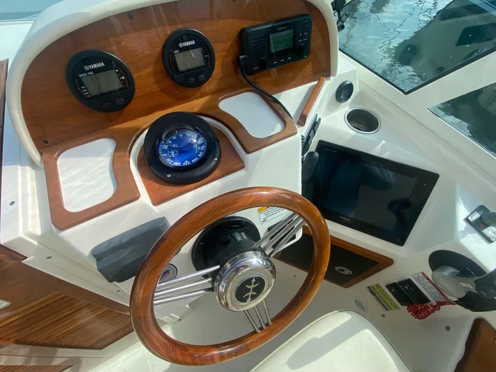 Yacht Photos Pics 2019 Hunt Yachts Harrier 26 helm with wooden steering wheel and navigation instruments.