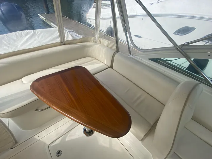  Yacht Photos Pics 2019 Hunt Yachts Harrier 26 interior with elegant wooden table and white seating.