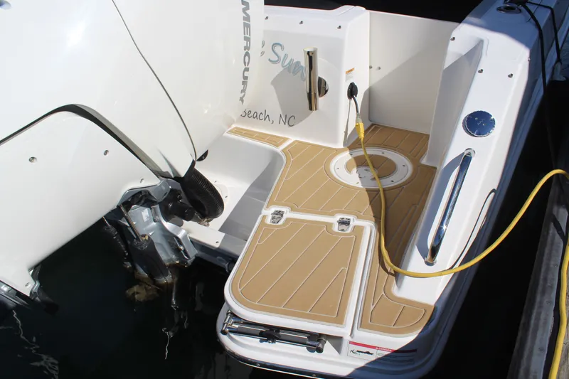Going To The Sun Yacht Photos Pics Stern area of a 2023 Boston Whaler 240 Vantage boat with engine.