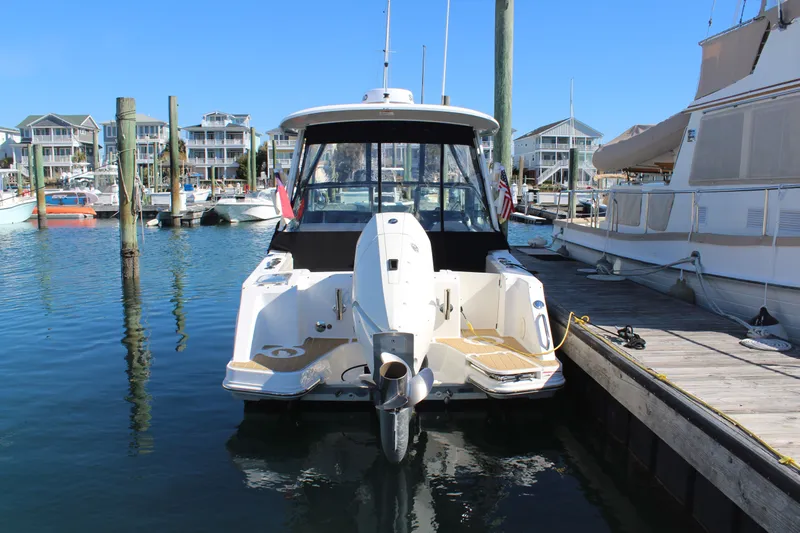 Going To The Sun Yacht Photos Pics Boston Whaler 240 Vantage 2023 docked, surrounded by boats.