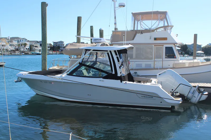 Going To The Sun Yacht Photos Pics 2023 Boston Whaler 240 Vantage boat docked in harbor.