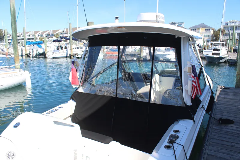 Going To The Sun Yacht Photos Pics Boston Whaler 240 Vantage 2023 docked with cover.