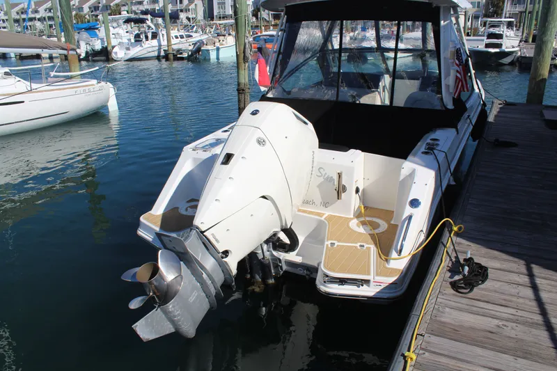 Going To The Sun Yacht Photos Pics Boston Whaler 240 Vantage 2023 at dock, outboard motor visible.