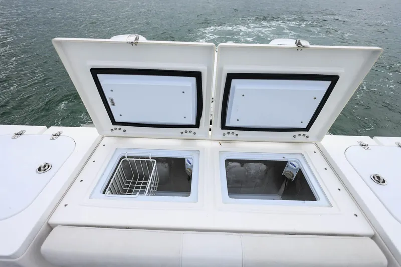  Yacht Photos Pics Open storage compartments on 2022 Sea Fox 368 Commander boat, with ocean in background.