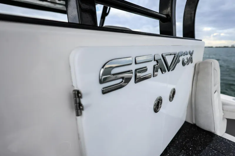  Yacht Photos Pics 2022 Sea Fox 368 Commander boat logo on white surface, ocean background.