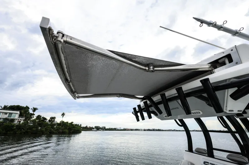  Yacht Photos Pics 2022 Sea Fox 368 Commander boat with extended canopy on a calm waterway.