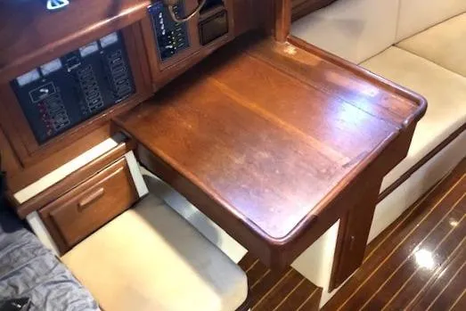 Sapphire Yacht Photos Pics Interior of 1992 Pacific Seacraft 37 sailboat with wooden table and seating area.