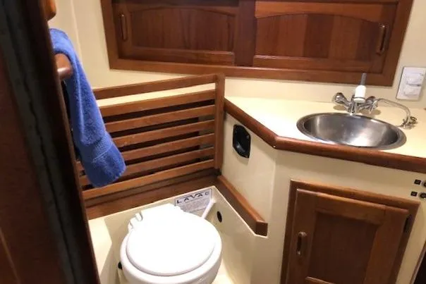 Sapphire Yacht Photos Pics 1992 Pacific Seacraft 37 yacht bathroom with wooden cabinetry and stainless steel sink.