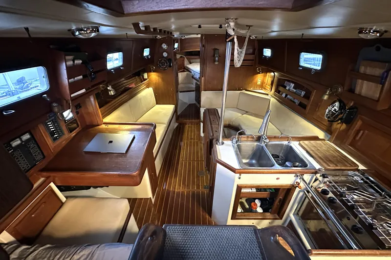 Sapphire Yacht Photos Pics Interior of 1992 Pacific Seacraft 37 sailboat with cozy seating and kitchen area.