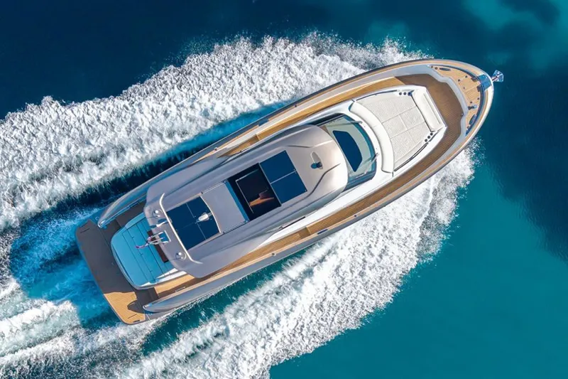  Yacht Photos Pics Aerial view of 2026 Solaris Power 52 Coupe yacht cruising on clear blue water.