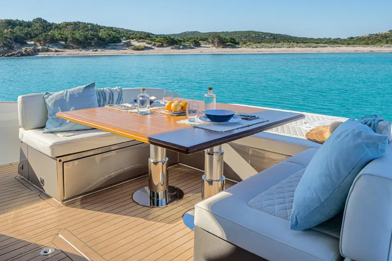  Yacht Photos Pics Luxurious 2026 Solaris Power 52 Coupe yacht dining area with ocean view.
