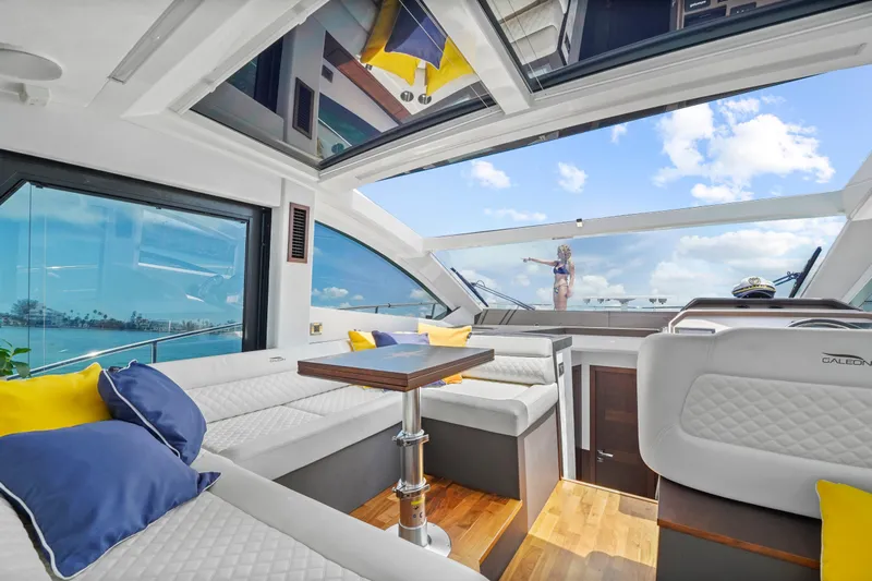 Good Vibes Yacht Photos Pics Luxurious interior of 2022 Galeon 470 Sky yacht with panoramic windows and plush seating.