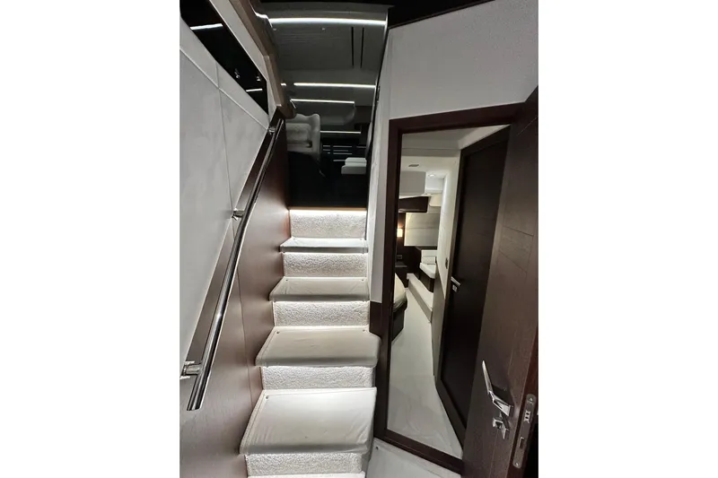 Good Vibes Yacht Photos Pics Interior staircase of 2022 Galeon 470 Sky yacht, featuring modern design and ambient lighting.