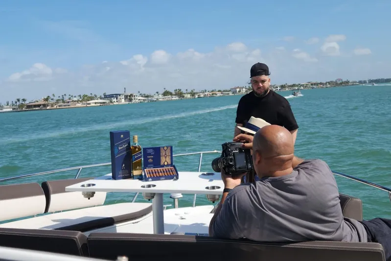 Good Vibes Yacht Photos Pics Man photographing on Galeon 470 Sky yacht with whiskey and cigars, 2022.
