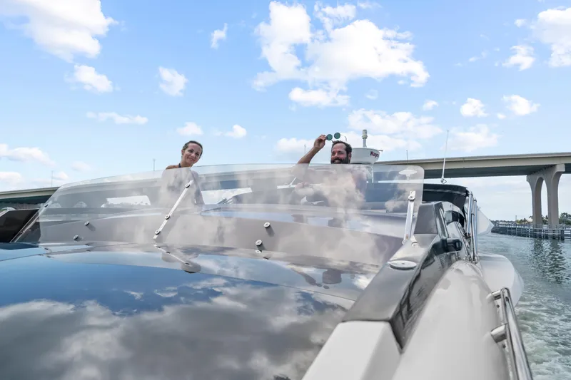 Good Vibes Yacht Photos Pics 2022 Galeon 470 Sky yacht cruising under a bridge with two people on deck.