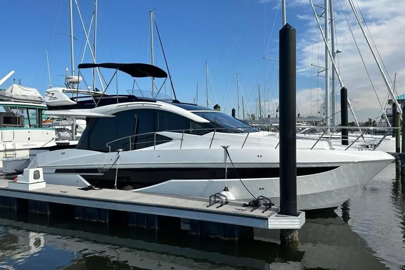 Good Vibes Yacht Photos Pics 2022 Galeon 470 Sky yacht docked at marina under clear blue sky.