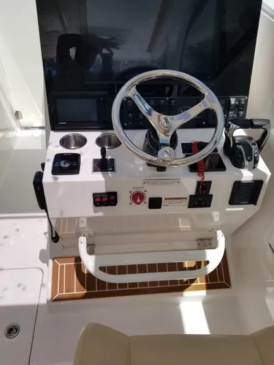 Nauti Nole Yacht Photos Pics 2021 Southport 33 DC helm with steering wheel and controls.
