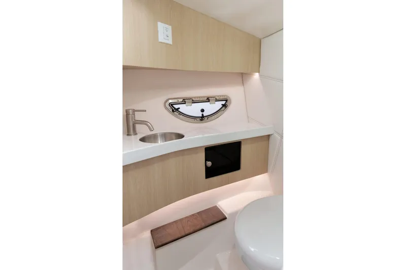  Yacht Photos Pics 2026 Regal LS9 boat interior bathroom with sink, faucet, and porthole window.