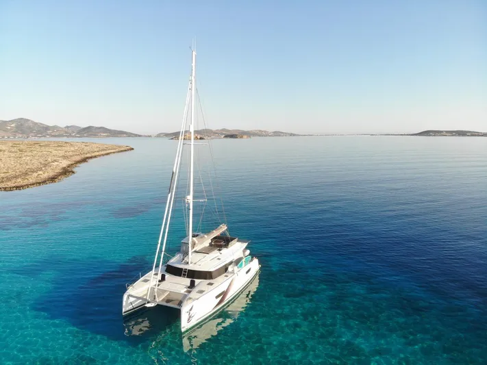 Spirit Of Ecstacy Yacht Photos Pics 2023 Fountaine Pajot Tanna 47 catamaran sailing in clear blue waters.