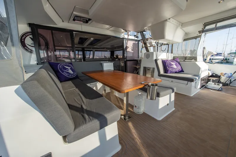 Spirit Of Ecstacy Yacht Photos Pics 2023 Fountaine Pajot Tanna 47 yacht interior with seating and table.