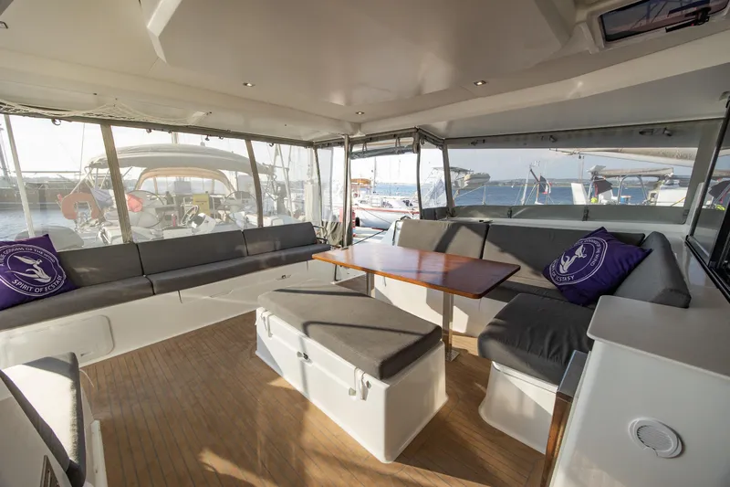 Spirit Of Ecstacy Yacht Photos Pics Spacious interior of 2023 Fountaine Pajot Tanna 47 catamaran with modern seating and table.