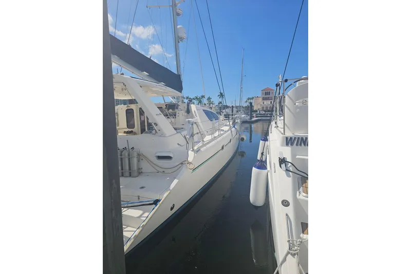 Beshert Yacht Photos Pics 2004 Leopard 47 yacht docked in a sunny marina.