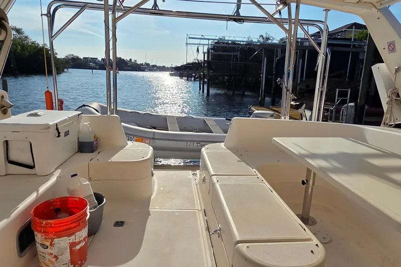 Beshert Yacht Photos Pics Leopard 47 catamaran interior with dock view, 2004 model, sunny waterfront setting.