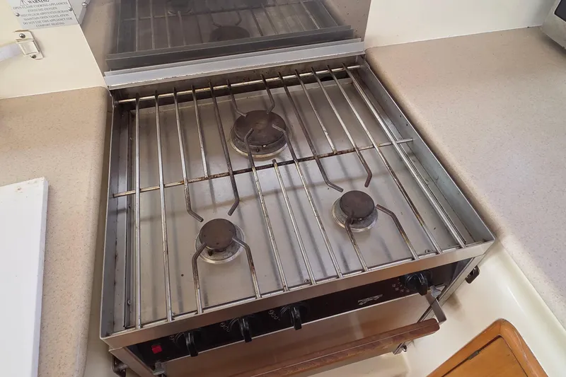 Beshert Yacht Photos Pics Three-burner gas stove in a 2004 Leopard 47 yacht kitchen.