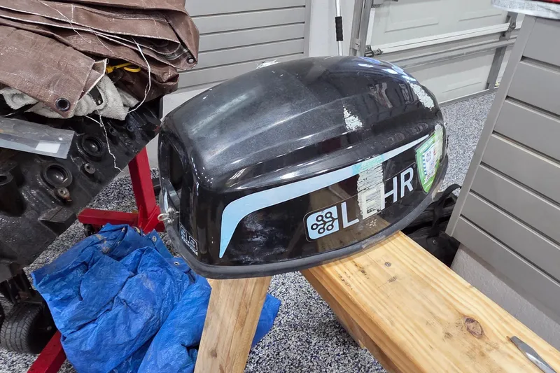 Beshert Yacht Photos Pics Outboard motor cover on wooden stand, garage setting, Leopard 47, 2004 model.