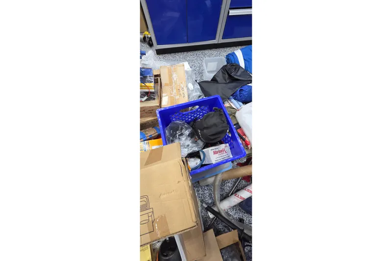 Beshert Yacht Photos Pics Messy workshop with tools, boxes, and supplies for Leopard 47, 2004 model.