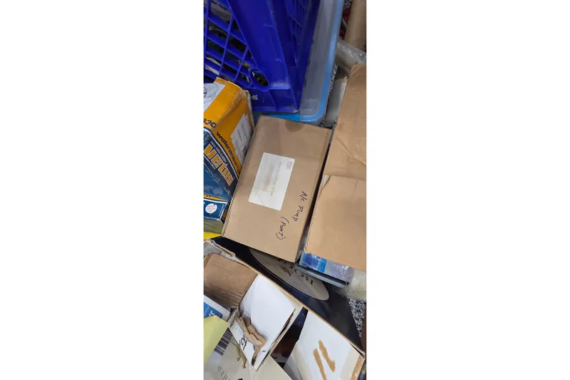 Beshert Yacht Photos Pics Boxes and crates stacked, labeled "Leopard 47," model year 2004.