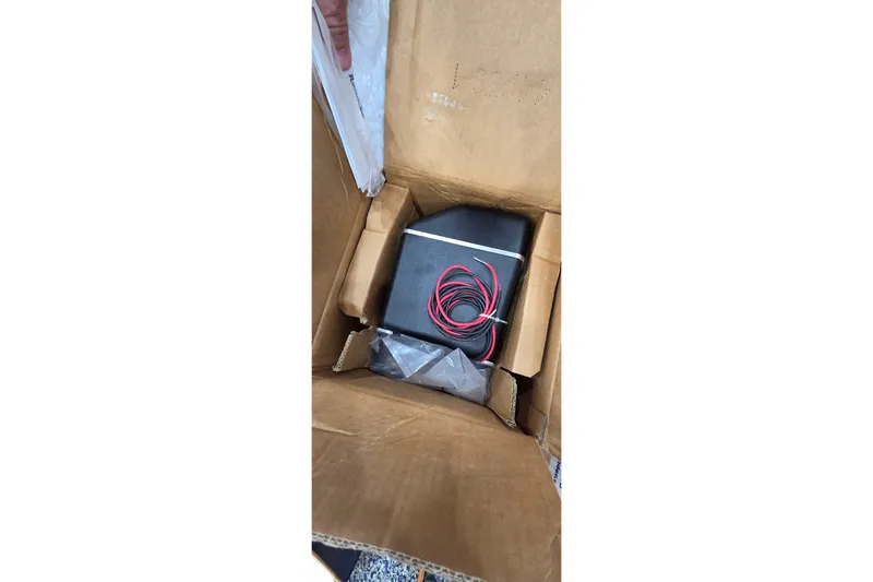 Beshert Yacht Photos Pics Cardboard box containing electronic device with red wires, Leopard 47 model, 2004.