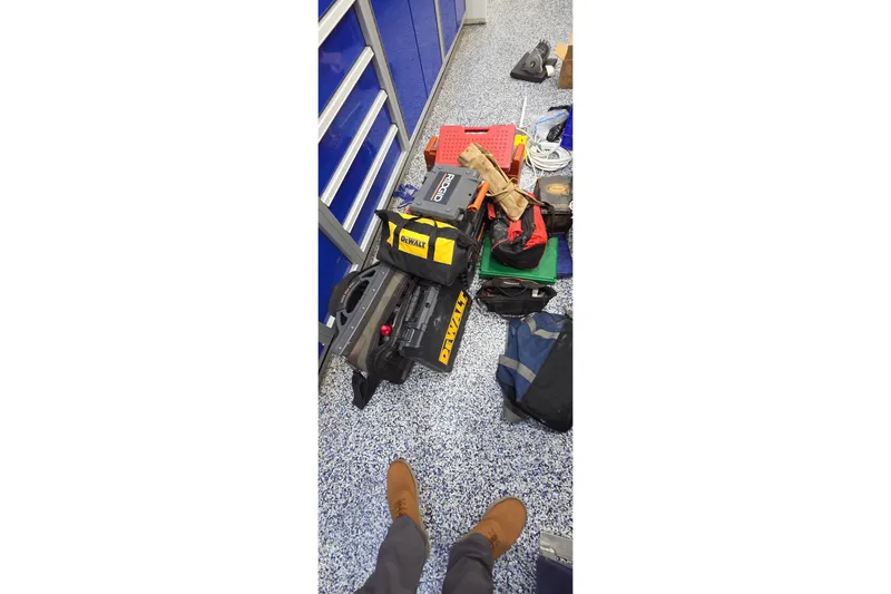 Beshert Yacht Photos Pics Tools and equipment on speckled floor near blue cabinets, Leopard 47, 2004.