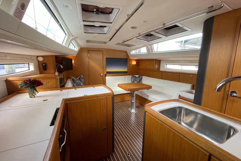 Seas The Day Yacht Photos Pics Luxurious interior of 2014 Bavaria Vision 46 yacht with modern wood finish and spacious seating.