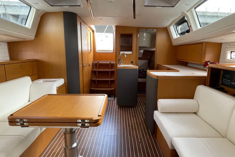 Seas The Day Yacht Photos Pics Interior of 2014 Bavaria Vision 46 yacht with modern wood finish and white seating.