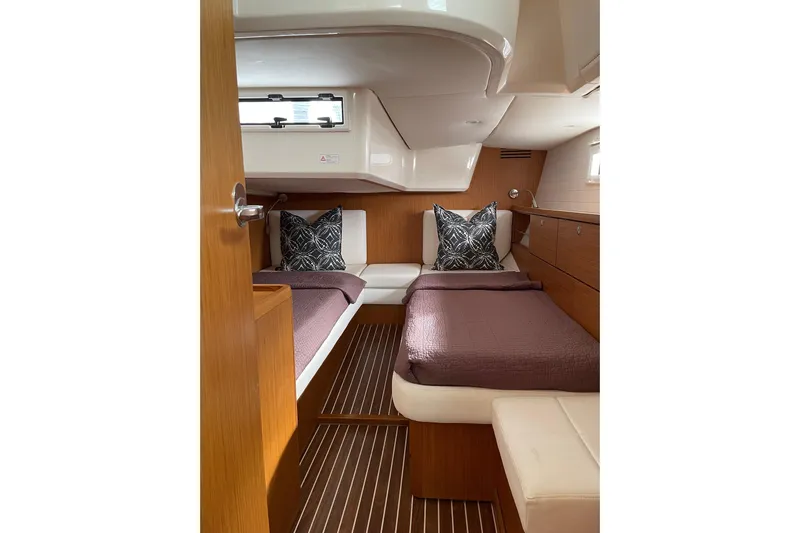 Seas The Day Yacht Photos Pics Interior cabin of 2014 Bavaria Vision 46 yacht with twin beds and wooden finish.