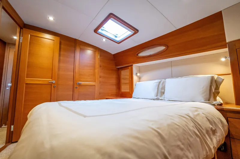 Carole Lyn Yacht Photos Pics Luxurious cabin interior of 2018 Palm Beach Motor Yachts PB55 with wood finish and skylight.