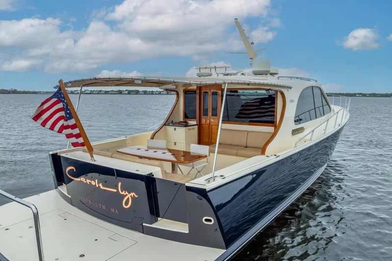 Carole Lyn Yacht Photos Pics 2018 Palm Beach Motor Yachts PB55 on water, featuring elegant design and American flag.