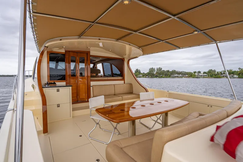 Carole Lyn Yacht Photos Pics 2018 Palm Beach Motor Yachts PB55, elegant interior with seating, table, and water view.