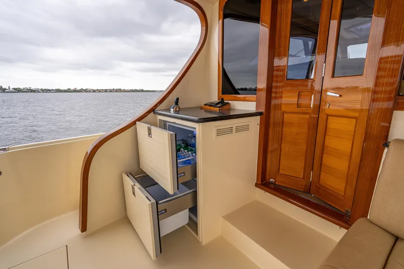 Carole Lyn Yacht Photos Pics Luxurious 2018 Palm Beach Motor Yachts PB55 interior with wooden doors and built-in fridge.