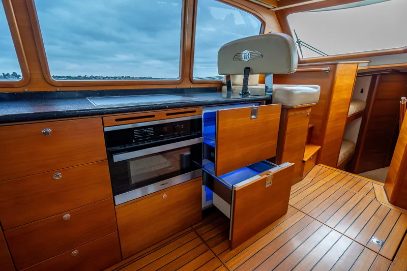 Carole Lyn Yacht Photos Pics Luxurious 2018 Palm Beach Motor Yachts PB55 interior with modern kitchen and elegant wood finish.