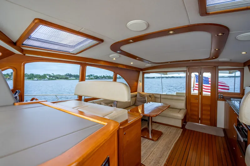Carole Lyn Yacht Photos Pics Luxurious interior of 2018 Palm Beach Motor Yachts PB55 with elegant wood finishes and waterfront view.