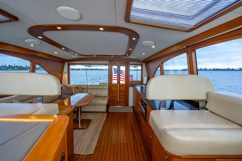 Carole Lyn Yacht Photos Pics Luxurious interior of 2018 Palm Beach Motor Yachts PB55 with elegant wood finishes and seating.